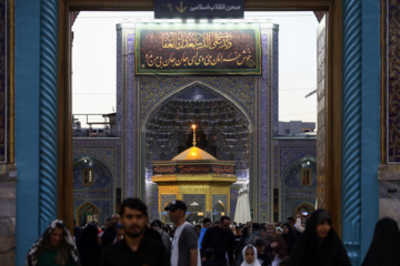 Servants change dome flag at Imam Reza (AS) shrine