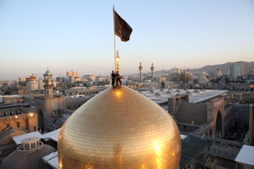 Servants change dome flag at Imam Reza (AS) shrine