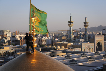 Servants change dome flag at Imam Reza (AS) shrine