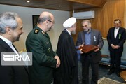 Who received badge of service in Iran anonymously?