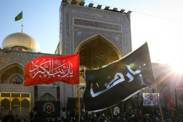 Servants change dome flag at Imam Reza (AS) shrine