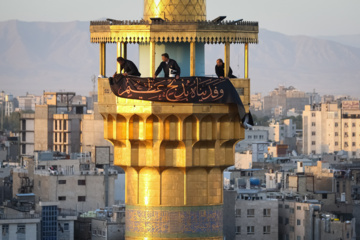 Servants change dome flag at Imam Reza (AS) shrine