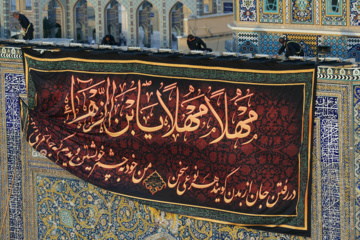 Servants change dome flag at Imam Reza (AS) shrine